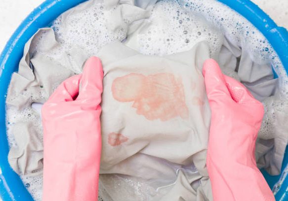 istockphoto-1293598239-612x612 Hands in rubber protective gloves washing sheet with blood stain in blue basin. Point of view shot. Closeup. Top down view.